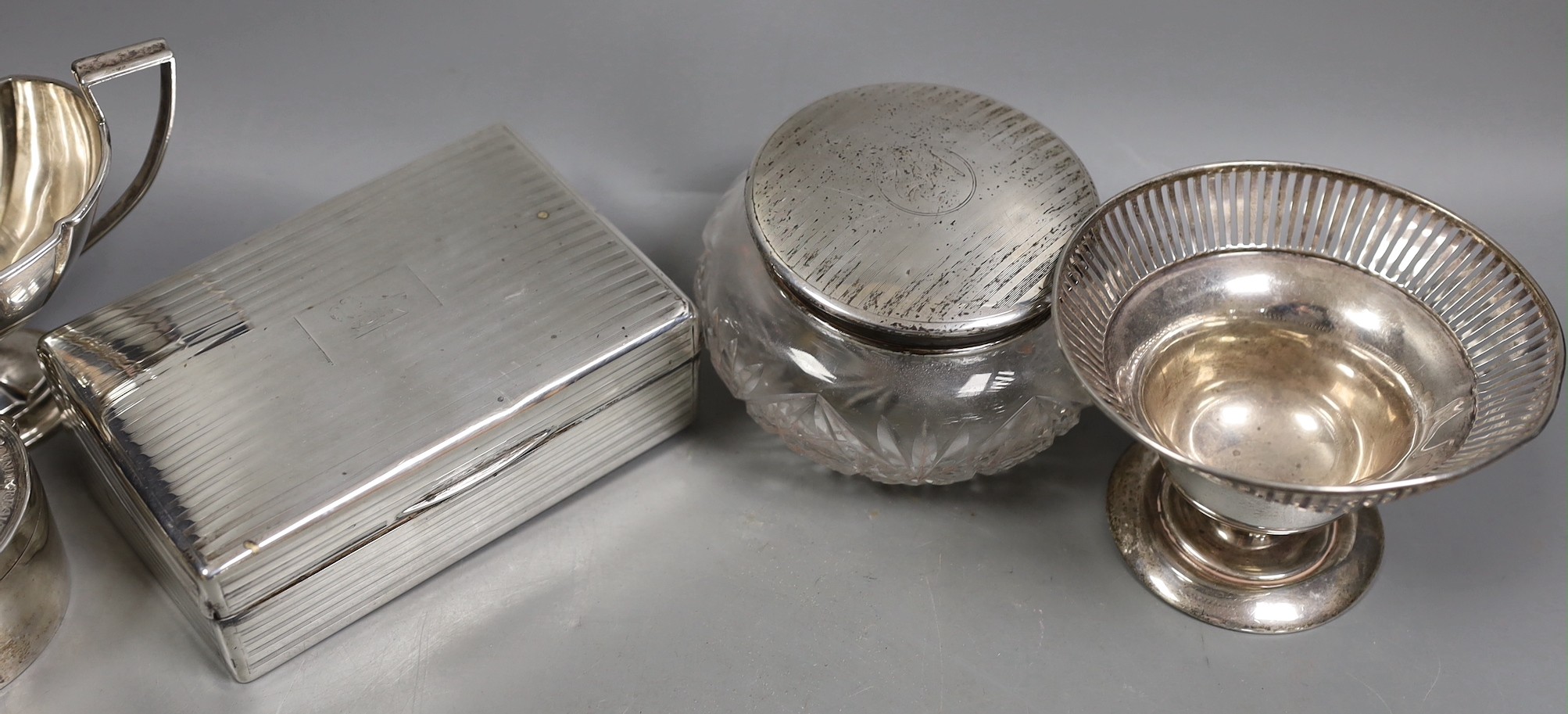 Miscellaneous silver ware including a mounted cigarette box, mounted posy vase, egg cup stand, late Victorian circular box and cover, repousse dish, eight sterling items including flatware and three other items.